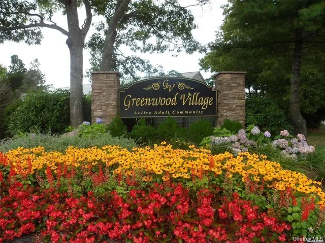 a sign that is in front of flowers