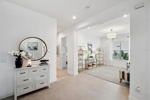 a bathroom with a tub double vanity sink and a mirror