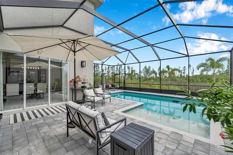 a bathroom with a sink a mirror a vanity and a shower