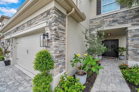 a view of a pathway with potted plants