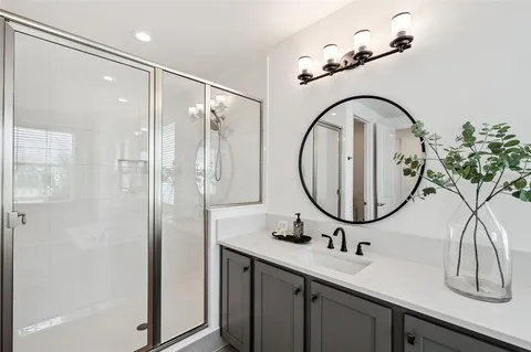 a bathroom with a sink a mirror a toilet and a mirror