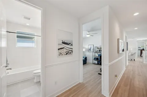 a bedroom with furniture and a wooden floor