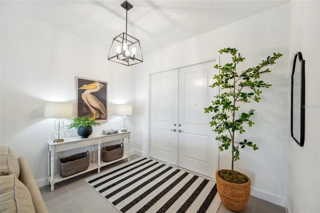 a living room with furniture and a chandelier