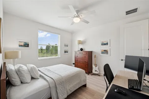 a view of a dining room and livingroom with furniture wooden floor a chandelier