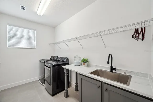 an aerial view of a house with swimming pool garden and lake view