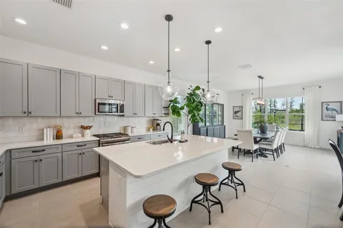 a dining room with furniture a chandelier and window