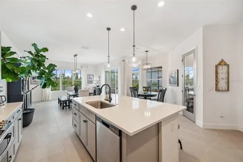 a dining room with furniture a chandelier and window