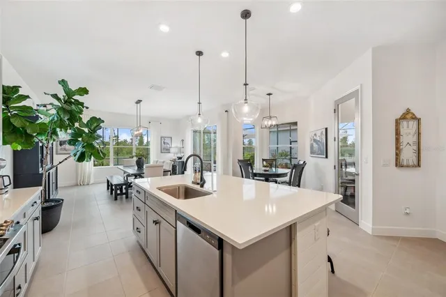 a dining room with furniture a chandelier and window