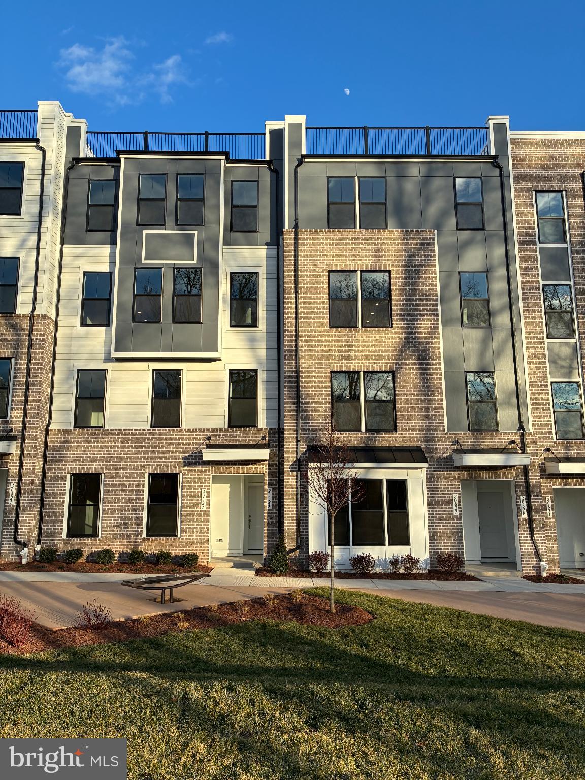 a front view of a building with a yard