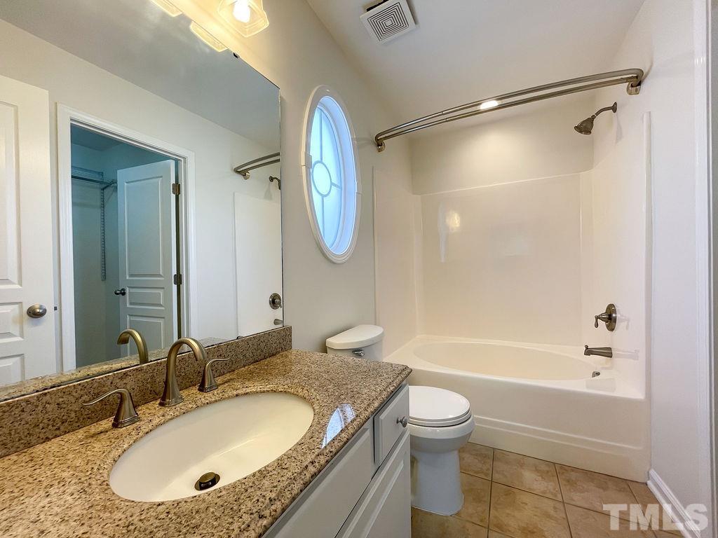 7841 Silverthread Lane Raleigh, NC 27617 - Photo 8 of 15 a bathroom with a granite countertop sink toilet tub and shower