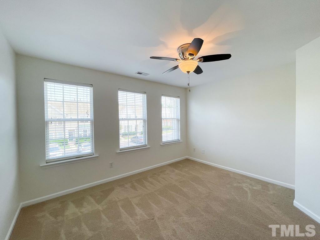 7841 Silverthread Lane Raleigh, NC 27617 - Photo 10 of 15 a view of a livingroom with a ceiling fan and window