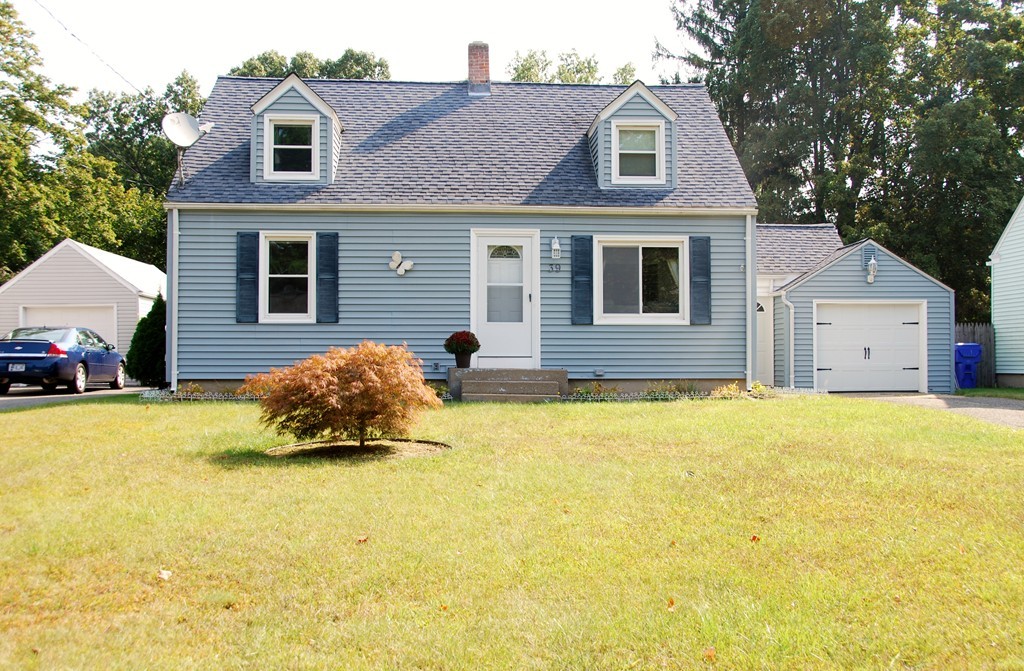 39 Lumae Street Springfield, MA 01119 - Photo 1 of 26 a front view of house with yard and trees in the background