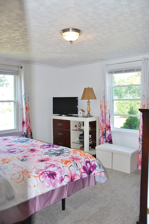 39 Lumae Street Springfield, MA 01119 - Photo 11 of 26 a bed room with a bed and a fireplace