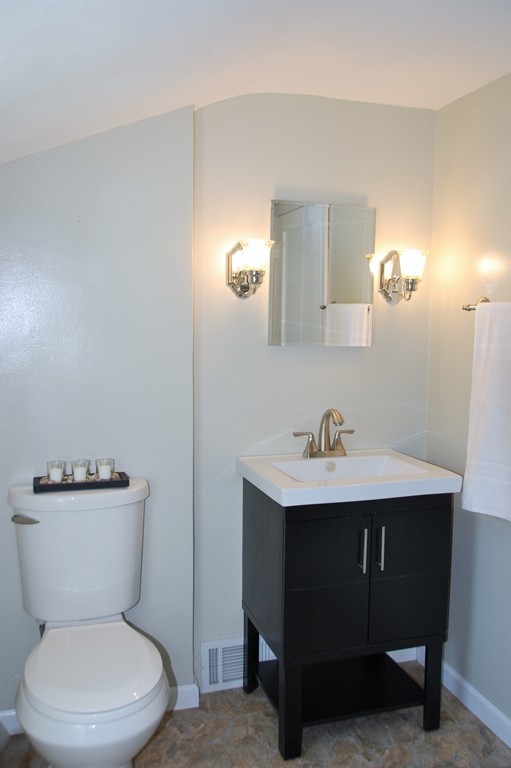 39 Lumae Street Springfield, MA 01119 - Photo 17 of 26 a white toilet sitting next to a bathroom sink