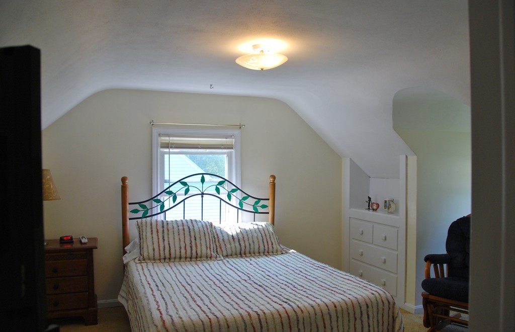 39 Lumae Street Springfield, MA 01119 - Photo 18 of 26 a bedroom with a bed and a chandelier
