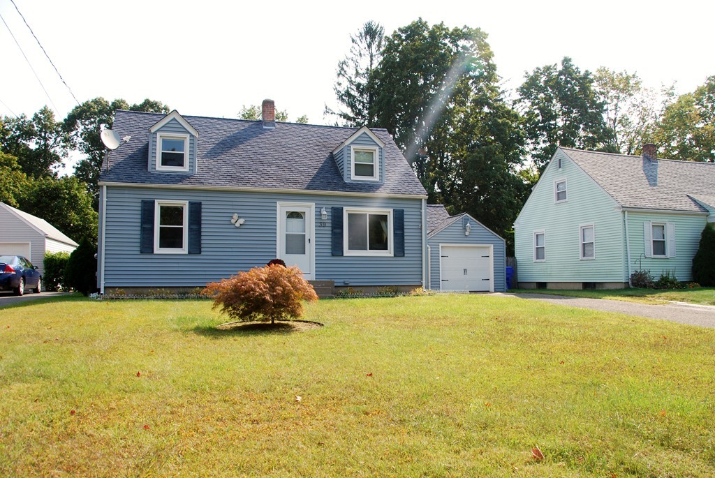 39 Lumae Street Springfield, MA 01119 - Photo 2 of 26 a front view of a house with yard and garage
