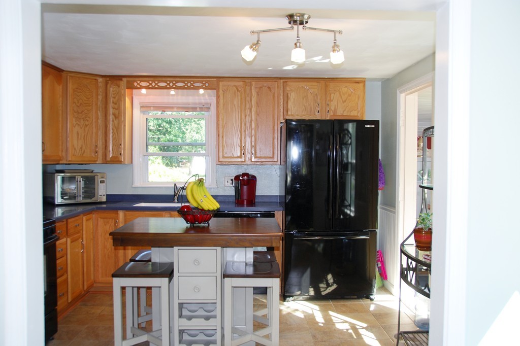 39 Lumae Street Springfield, MA 01119 - Photo 6 of 26 a kitchen with stainless steel appliances a stove window and cabinets