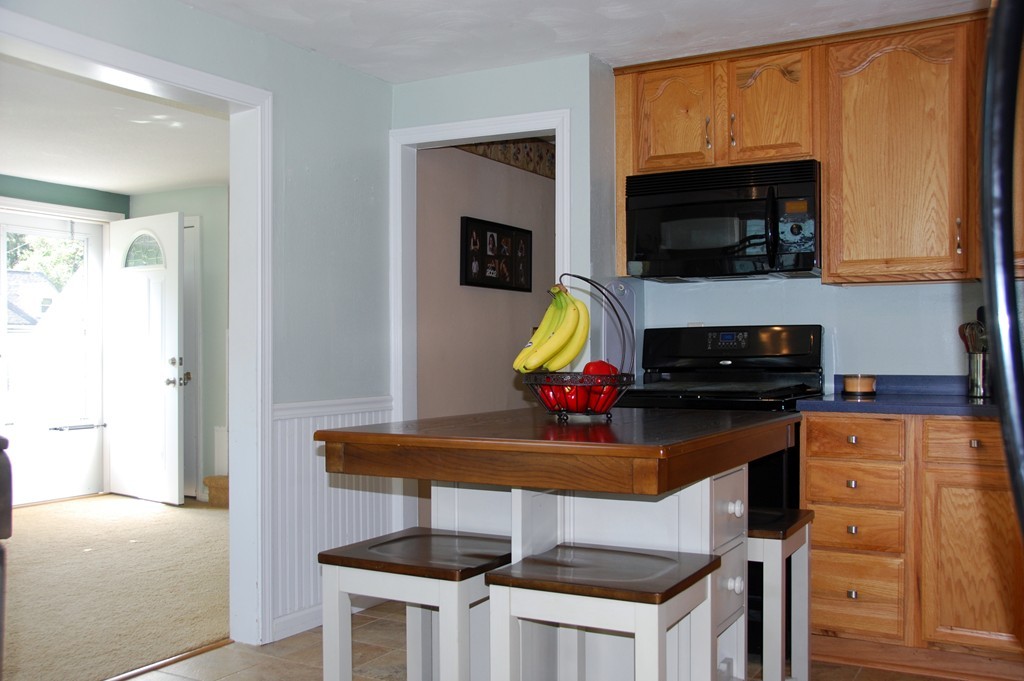 39 Lumae Street Springfield, MA 01119 - Photo 8 of 26 a kitchen with a stove and a microwave