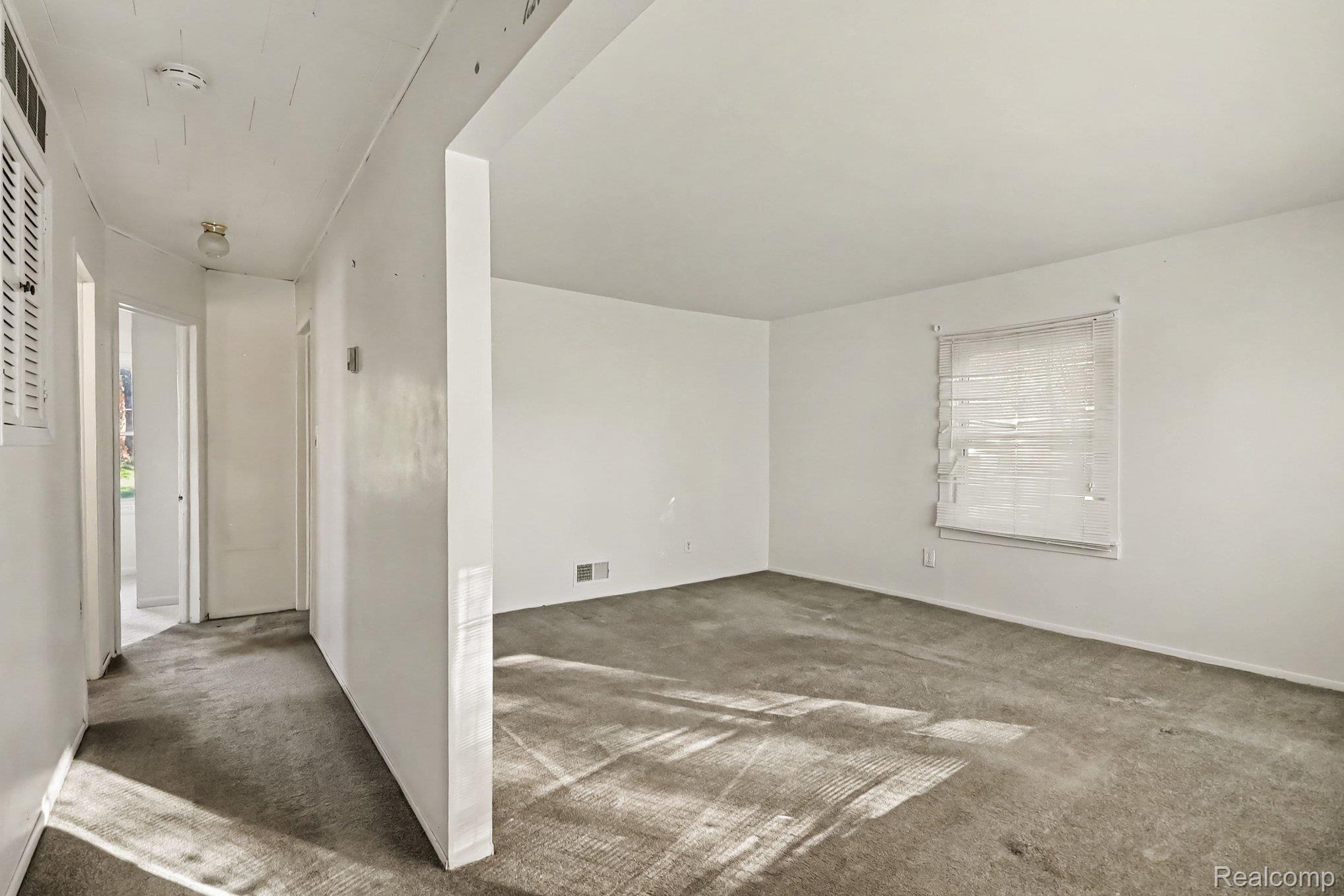 32694 Ruehle Avenue Warren, MI 48093 - Photo 4 of 15 Neutral wall finishes, window with blinds, carpeted flooring, and an overhead light fixture