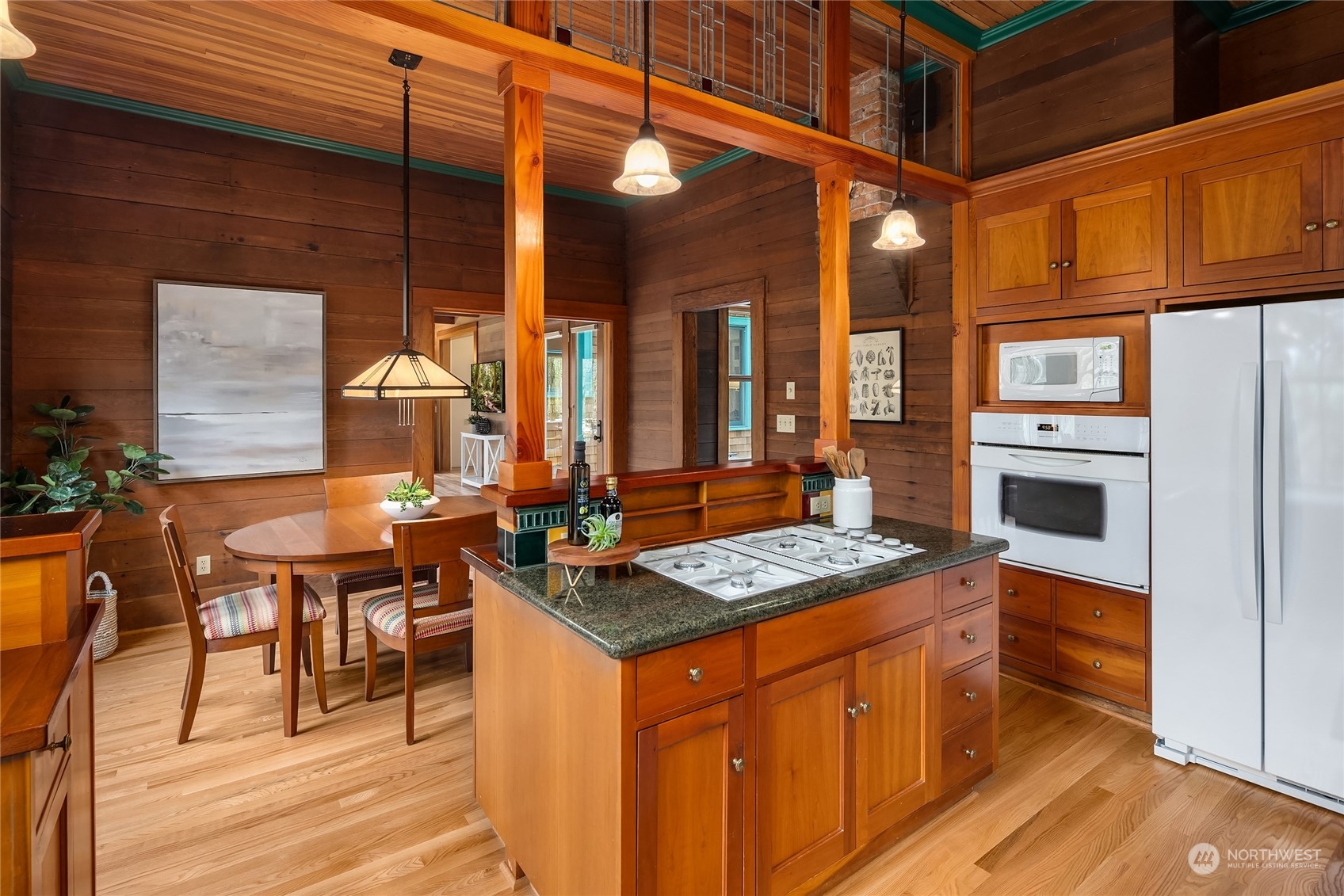 8251 Northeast Beck Road Bainbridge Island, WA 98110 - Photo 12 of 40 a open kitchen with stainless steel appliances granite countertop a stove a sink and a microwave