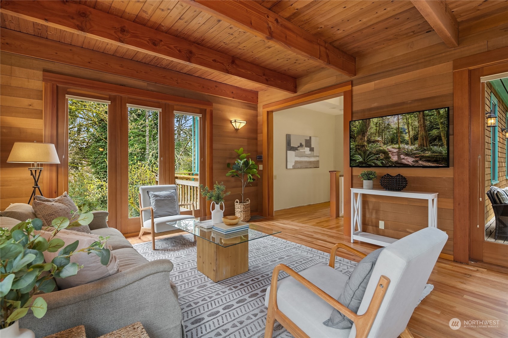 8251 Northeast Beck Road Bainbridge Island, WA 98110 - Photo 16 of 40 a living room with furniture a flat screen tv and floor to ceiling windows