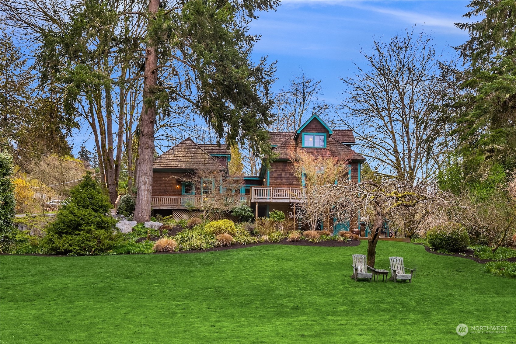 8251 Northeast Beck Road Bainbridge Island, WA 98110 - Photo 2 of 40 a front view of a house with a garden