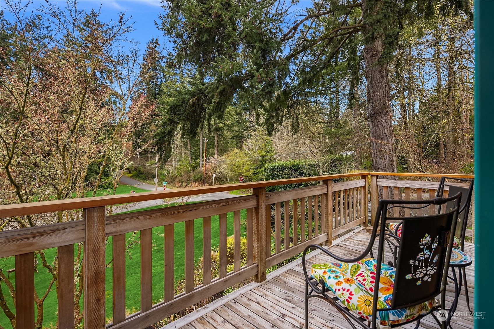 8251 Northeast Beck Road Bainbridge Island, WA 98110 - Photo 21 of 40 a view of a wooden deck with chairs and a table