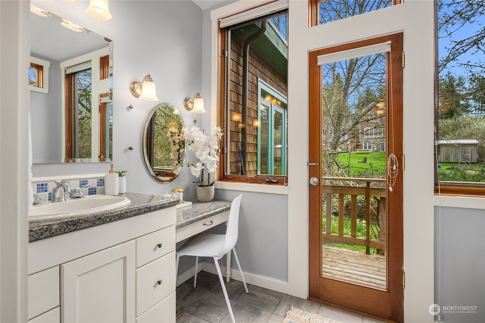 8251 Northeast Beck Road Bainbridge Island, WA 98110 - Photo 23 of 40 a en suite bathroom with a granite countertop sink and a mirror
