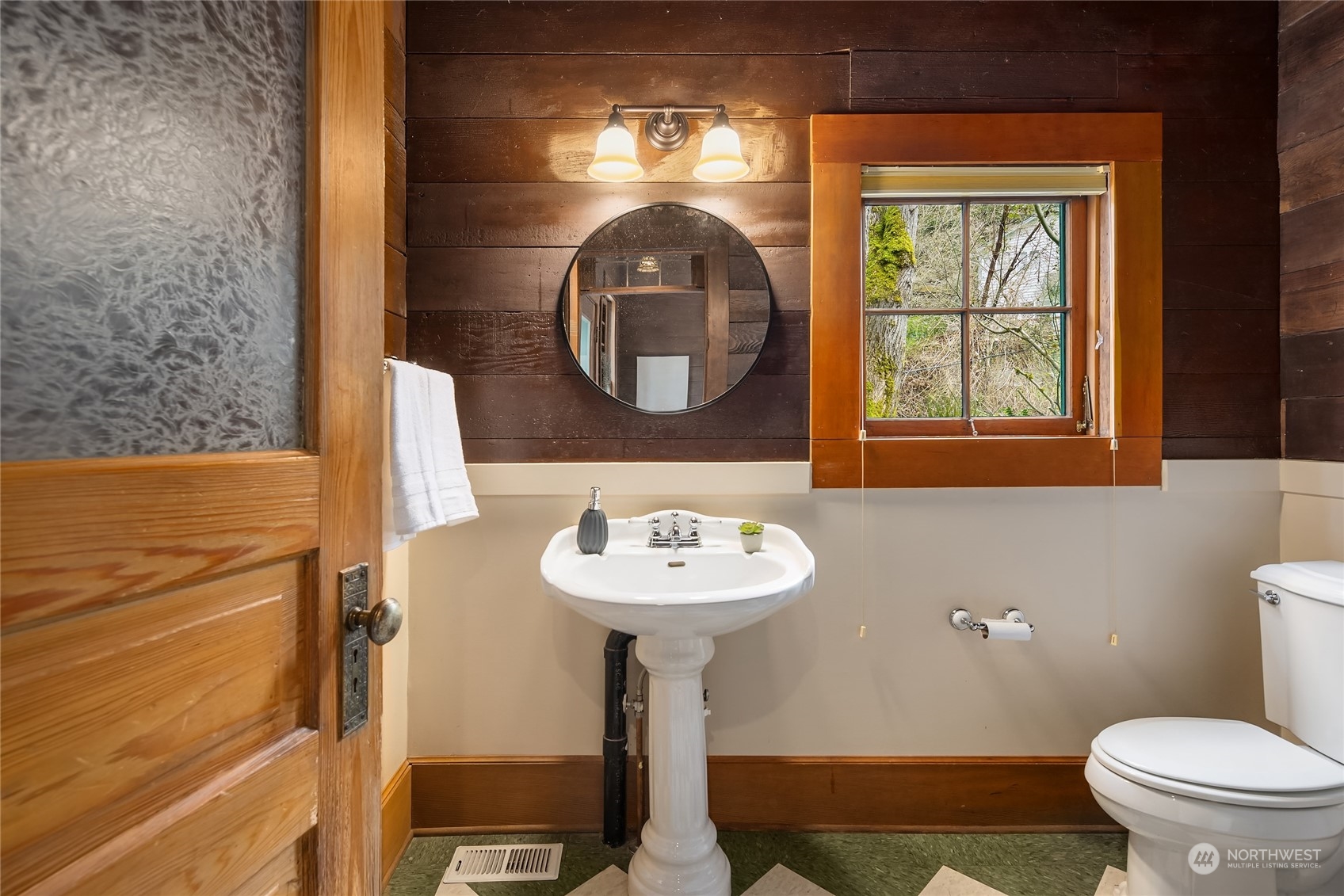 8251 Northeast Beck Road Bainbridge Island, WA 98110 - Photo 26 of 40 a bathroom with a sink a mirror and a toilet