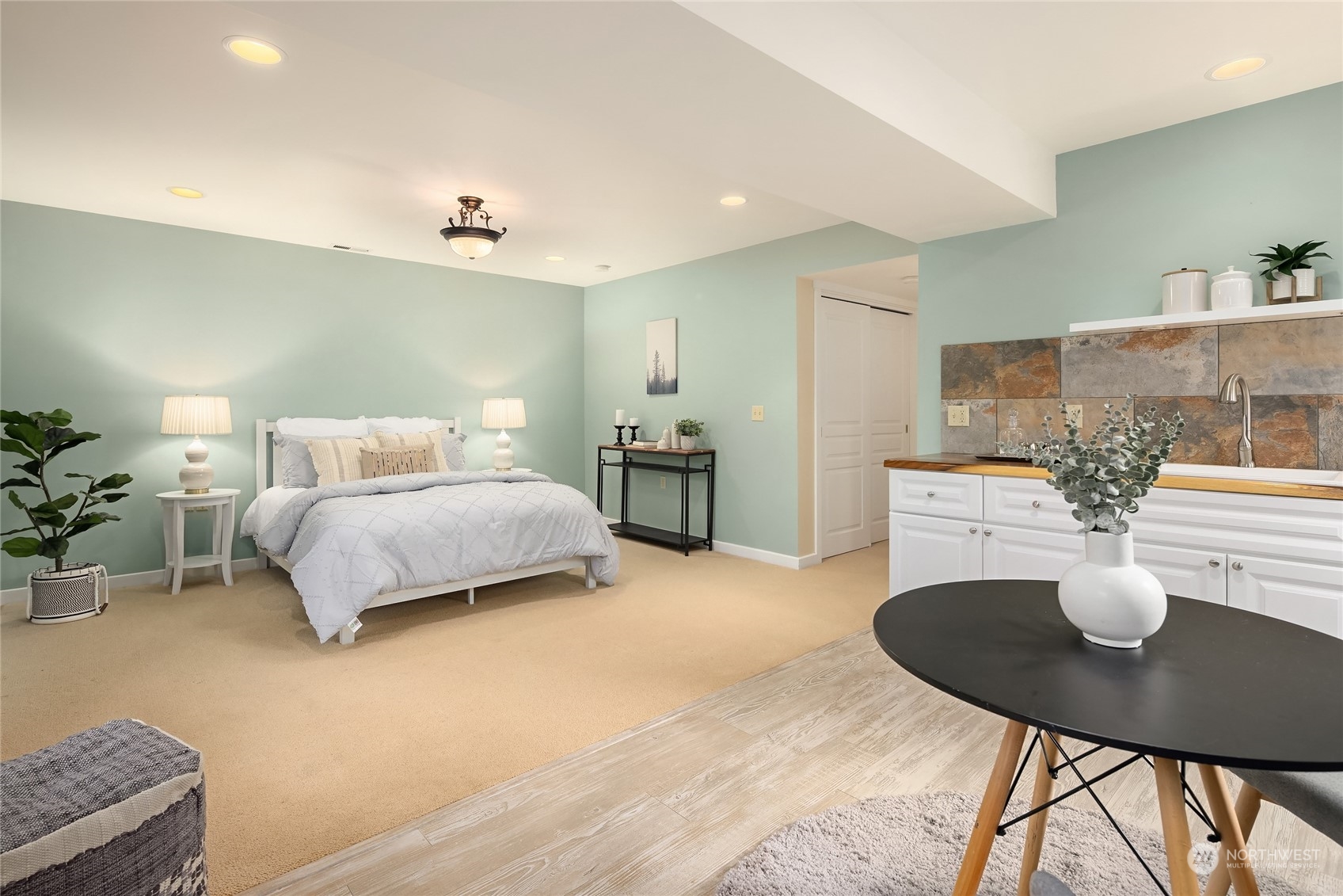 8251 Northeast Beck Road Bainbridge Island, WA 98110 - Photo 31 of 40 a bedroom with a bed a table and chair