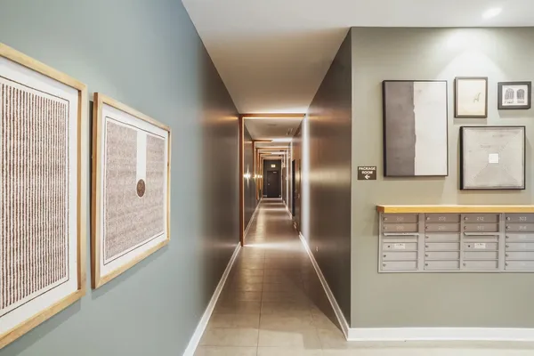 a view of a hallway with wooden floor