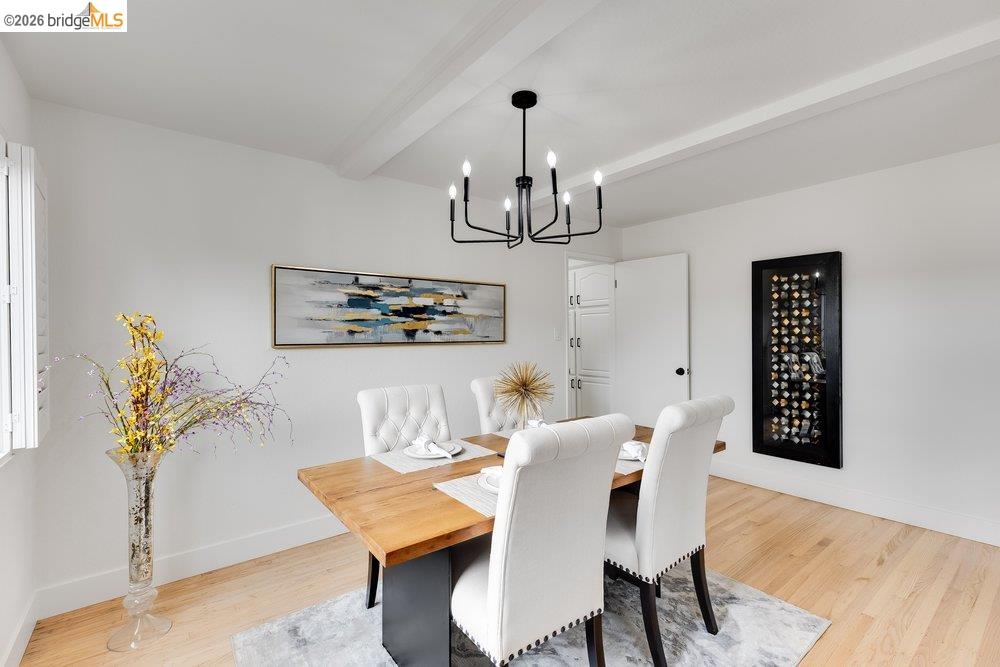 1298 Ribbon Street Foster City, CA 94404 - Photo 24 of 86 Dining area featuring a modern black chandelier, white ceiling beams, and wood-finish flooring
