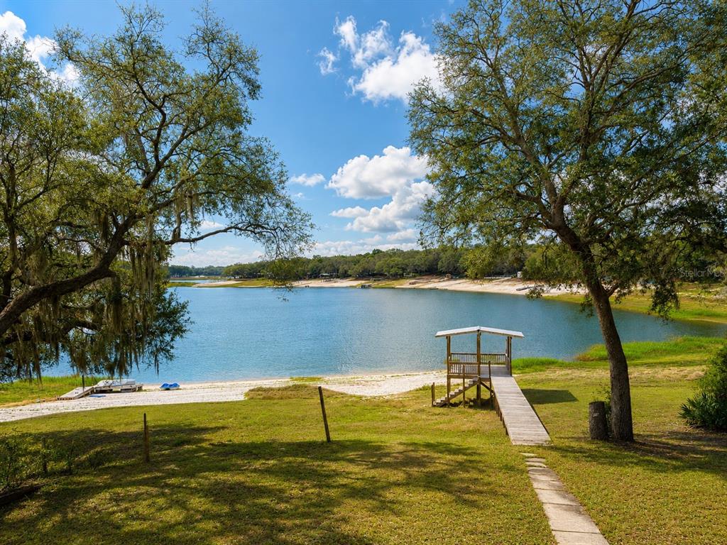 7119 Immokalee Road Keystone Heights, FL 32656 - Photo 46 of 50 a view of a lake with a outdoor space