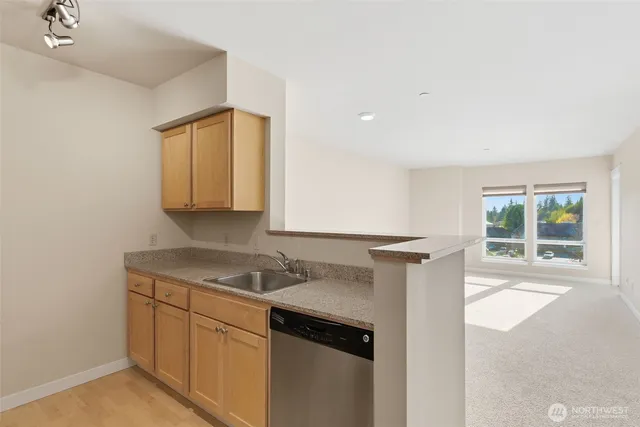 a kitchen with a sink cabinets and window