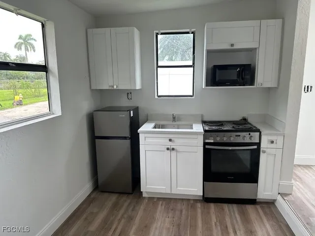 a kitchen with a stove and a refrigerator