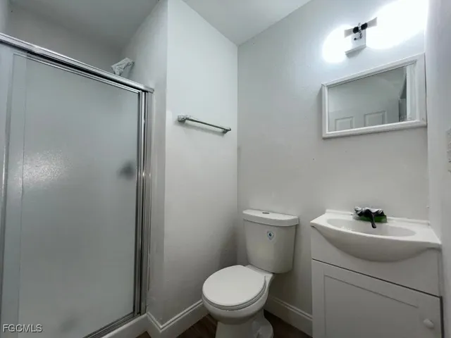 a bathroom with a sink toilet and a mirror