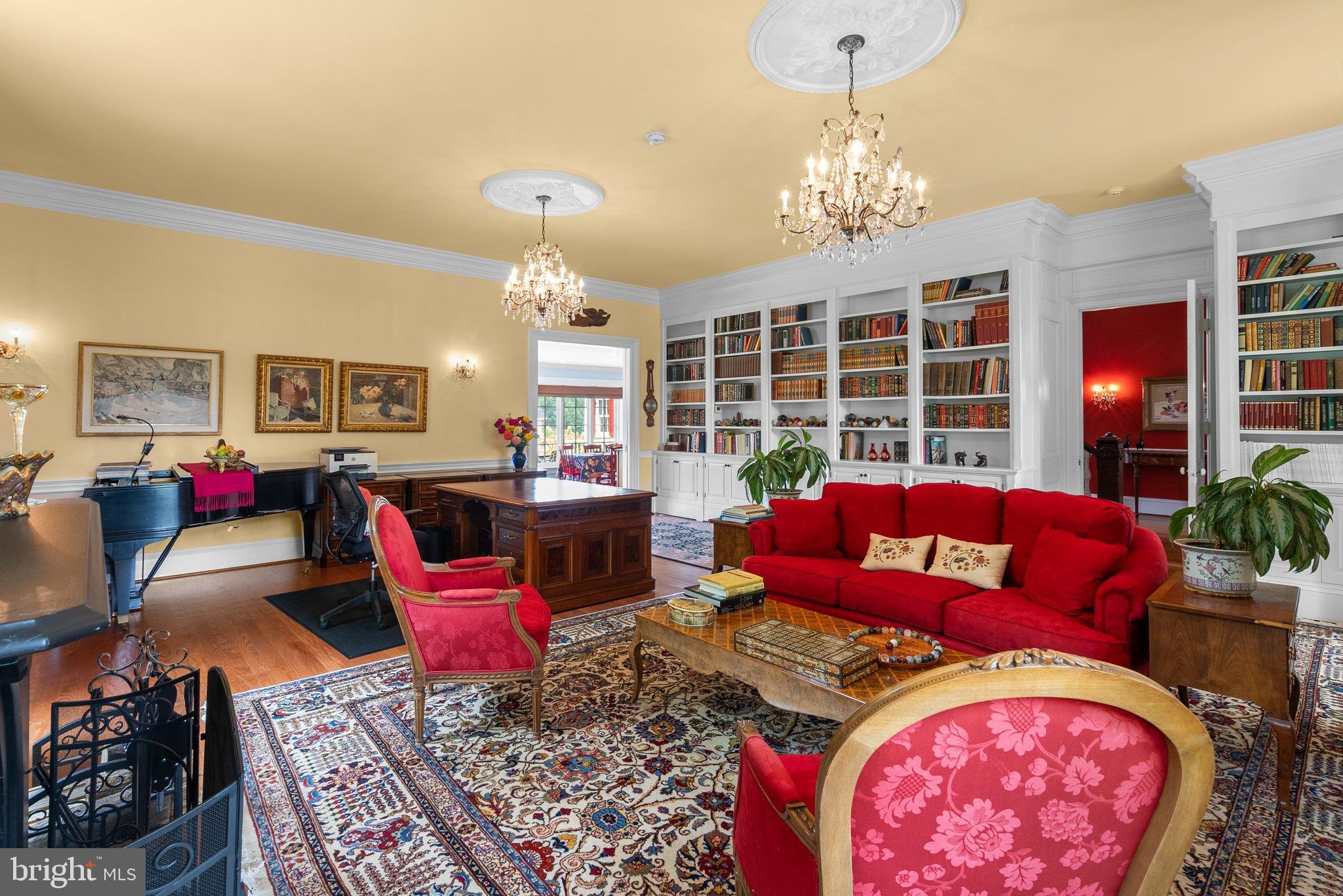 15701 Dr Bowen Road Aquasco, MD 20608 - Photo 25 of 89 a living room with furniture a chandelier and a fireplace