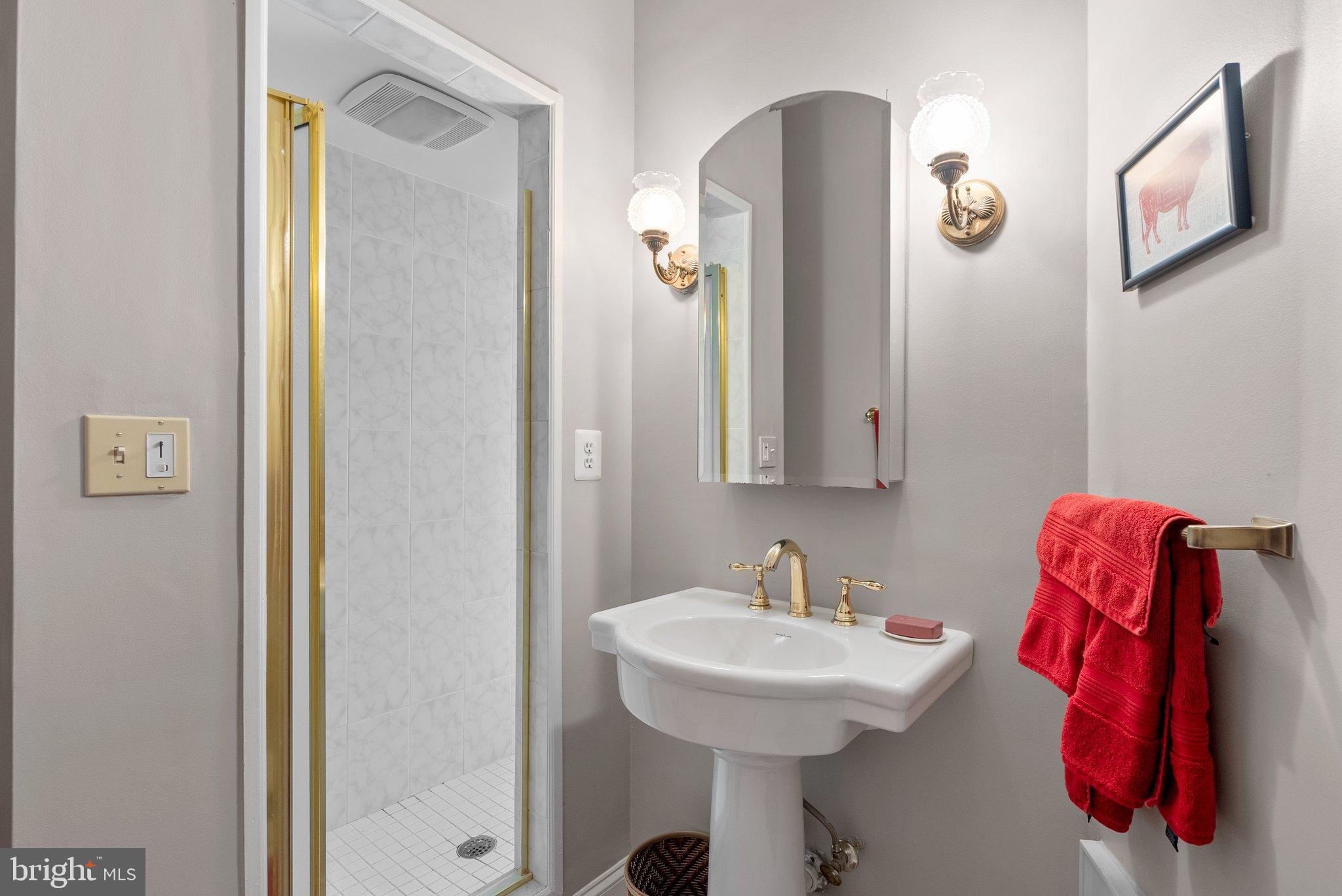 15701 Dr Bowen Road Aquasco, MD 20608 - Photo 31 of 89 a bathroom with a sink and mirror