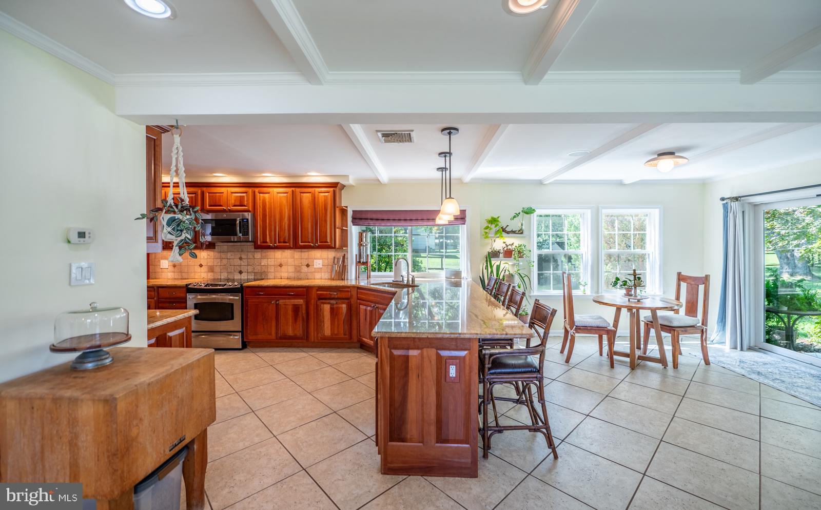 22 Salisbury Lane Malvern, PA 19355 - Photo 12 of 57 a kitchen with stainless steel appliances kitchen island granite countertop a sink and cabinets