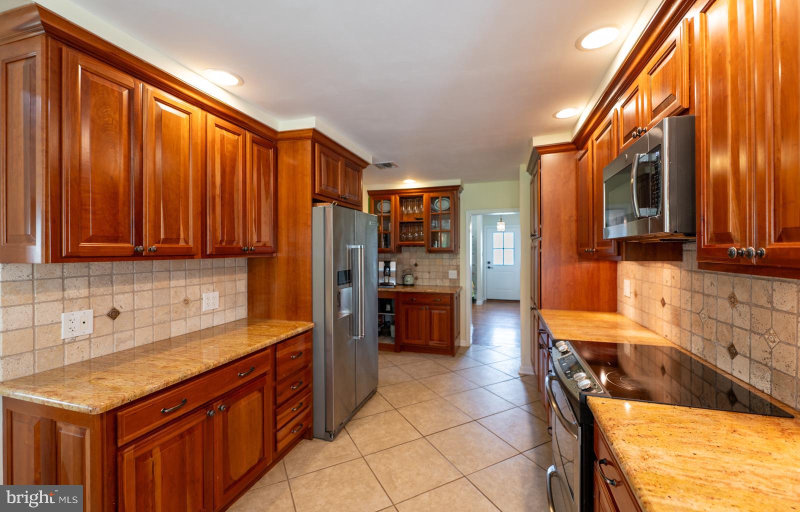 22 Salisbury Lane Malvern, PA 19355 - Photo 13 of 57 a kitchen with stainless steel appliances granite countertop a sink and cabinets