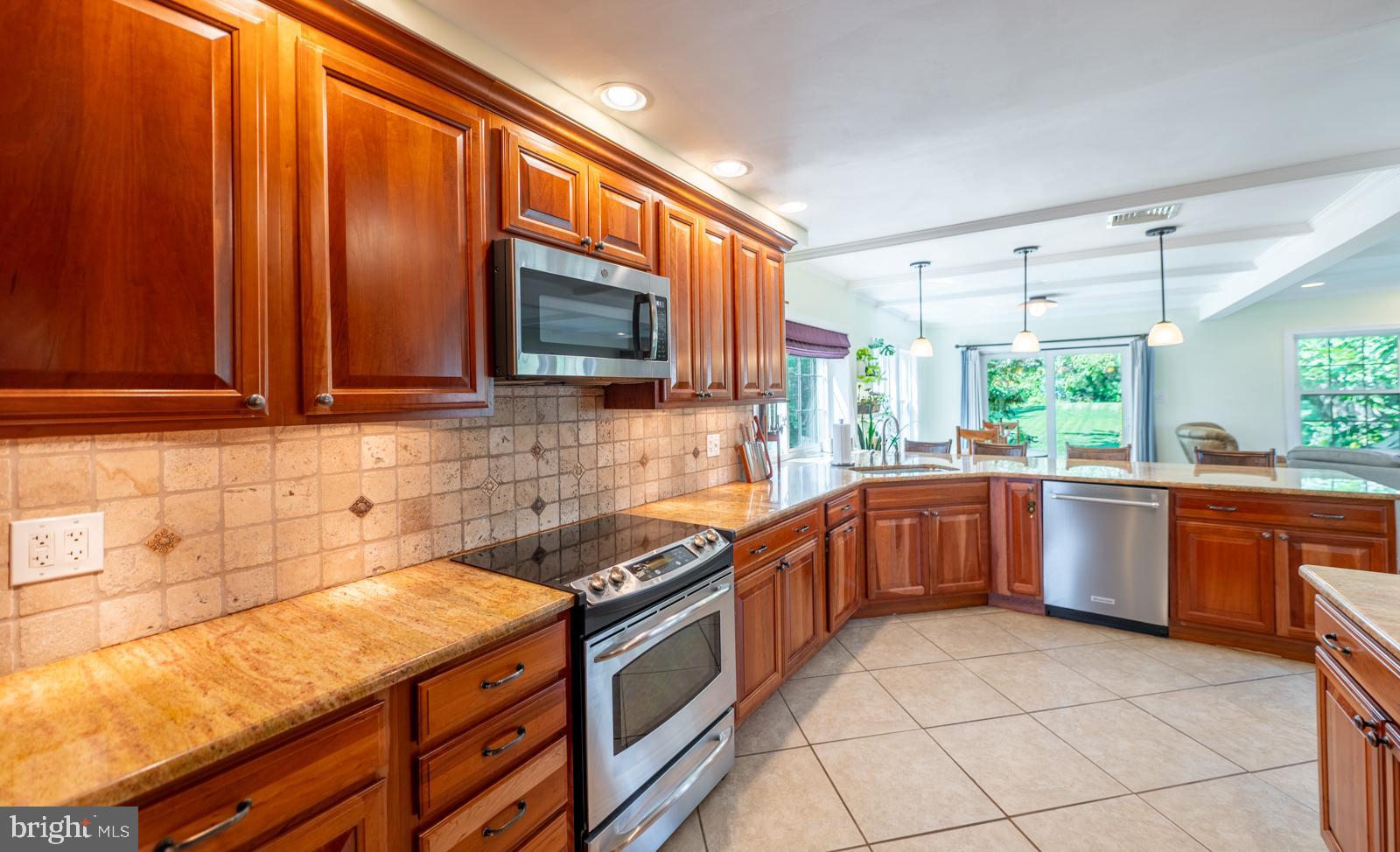 22 Salisbury Lane Malvern, PA 19355 - Photo 15 of 57 a kitchen with stainless steel appliances granite countertop wooden cabinets a stove top oven a sink and dishwasher