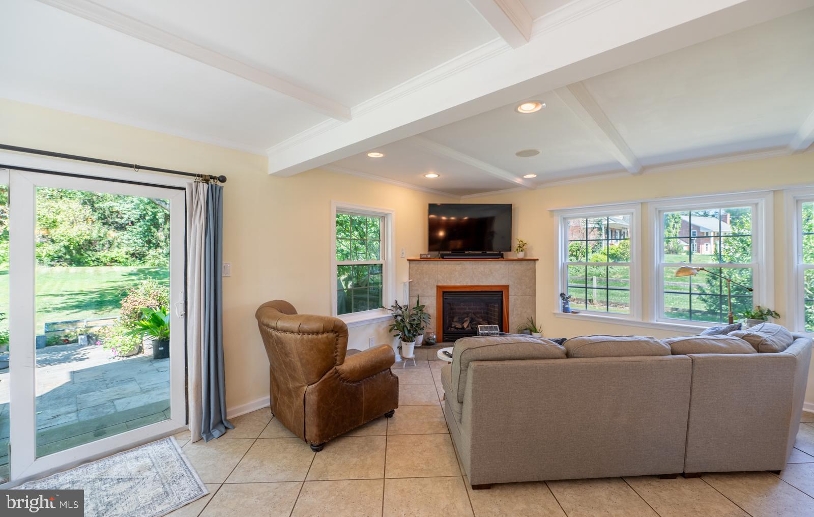 22 Salisbury Lane Malvern, PA 19355 - Photo 17 of 57 a living room with furniture a fireplace and a floor to ceiling window