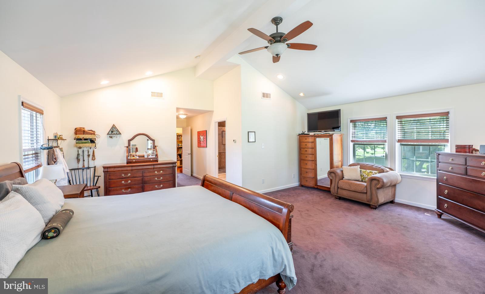 22 Salisbury Lane Malvern, PA 19355 - Photo 19 of 57 a spacious bedroom with a bed a couch and a large window