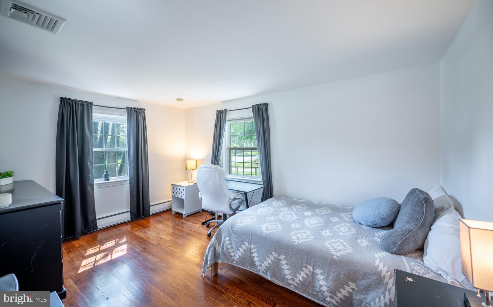 22 Salisbury Lane Malvern, PA 19355 - Photo 23 of 57 a bedroom with a bed and wooden floor
