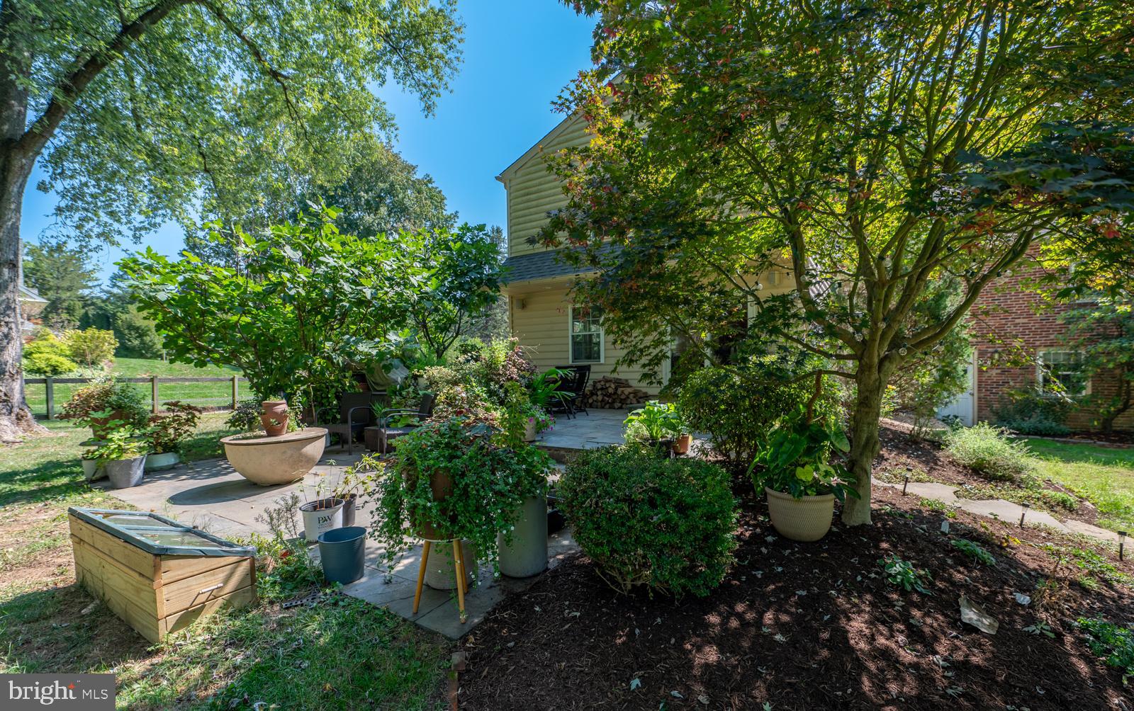 22 Salisbury Lane Malvern, PA 19355 - Photo 40 of 57 a view of a backyard with potted plants and large trees