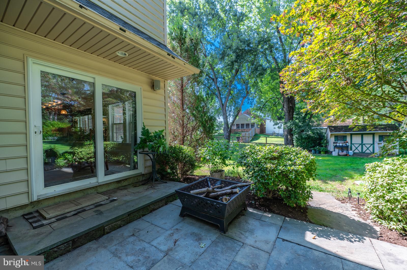 22 Salisbury Lane Malvern, PA 19355 - Photo 48 of 57 a backyard of a house with large trees and outdoor seating