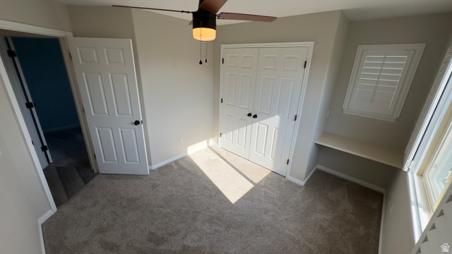 3547 East Golden Eagle Road Eagle Mountain, UT 84005 - Photo 23 of 47 Unfurnished bedroom with carpet flooring, a closet, and ceiling fan