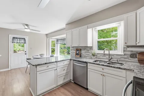 a kitchen with a sink stove and cabinets