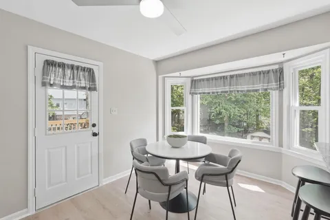 a dining room with furniture and window