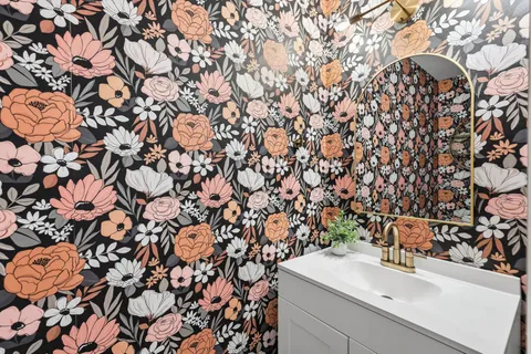 a bathroom with a sink and mirror with vanity